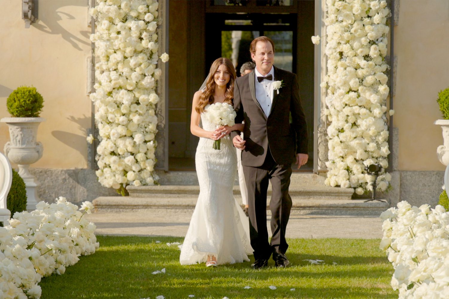 Bride walking down the aisle with her father during the ceremony at Villa Balbiano, Lake Como — captured by Koman Studio, fine-art wedding photographers in Italy.