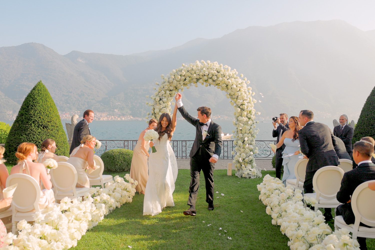 Bride and groom walk down the aisle as husband and wife after their ceremony at Villa Balbiano on Lake Como — captured by Koman Studio, fine-art wedding photographers in Italy.