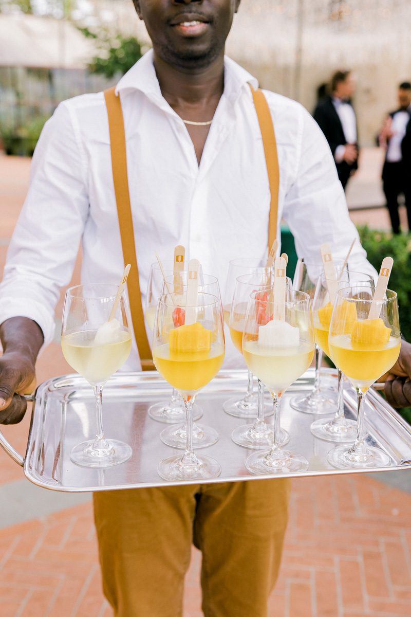 Guests enjoying Italian-inspired cocktail hour drinks at Borgo di Vignamaggio in Tuscany during a Chianti wedding celebration