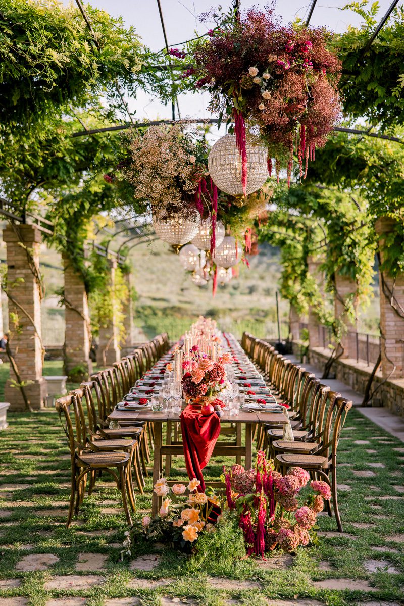 Reception dinner at Borgo di Vignamaggio in Tuscany with candlelit tables overlooking the Chianti countryside