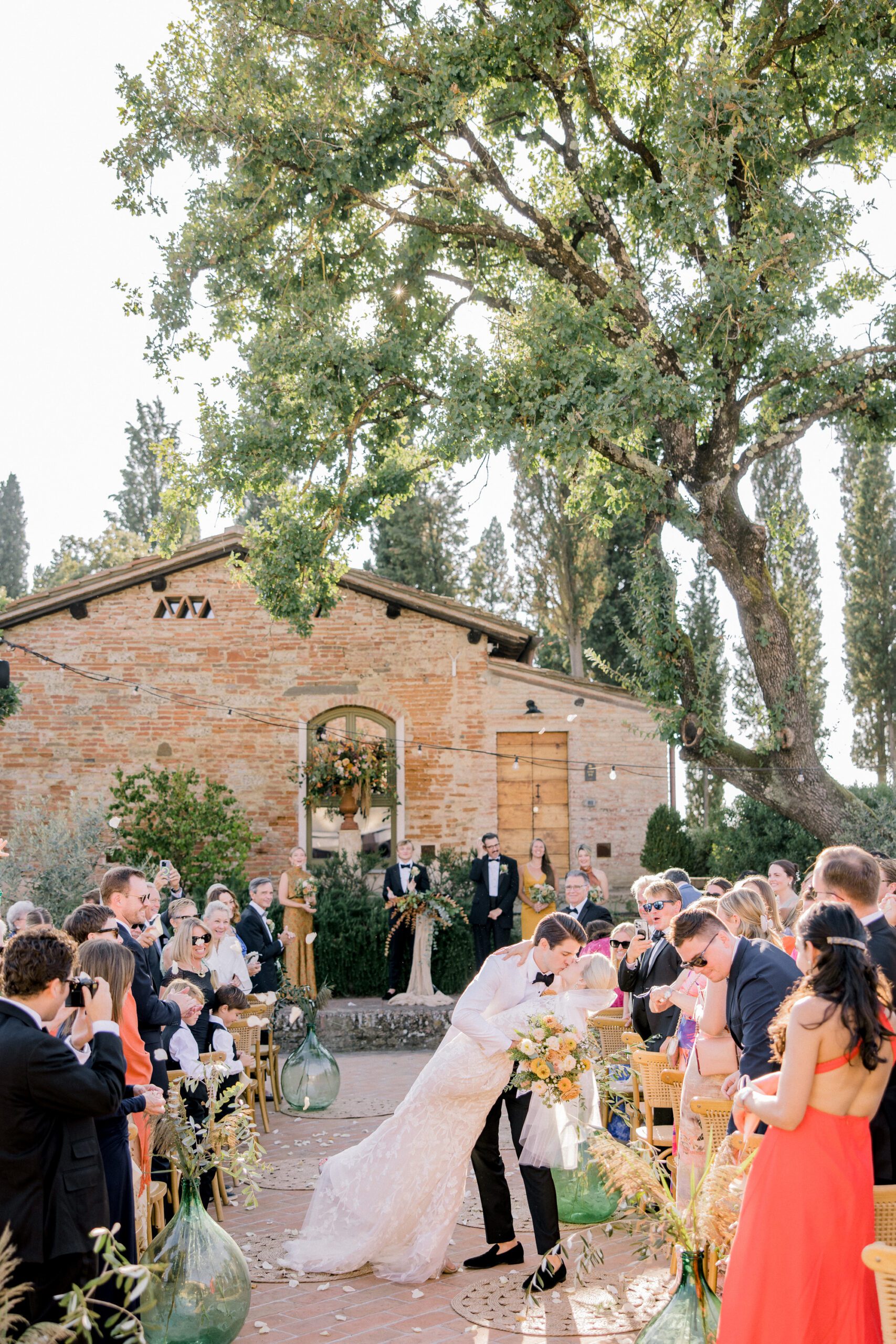 Outdoor wedding ceremony at Villa Petriolo in Tuscany surrounded by countryside views and autumn tones